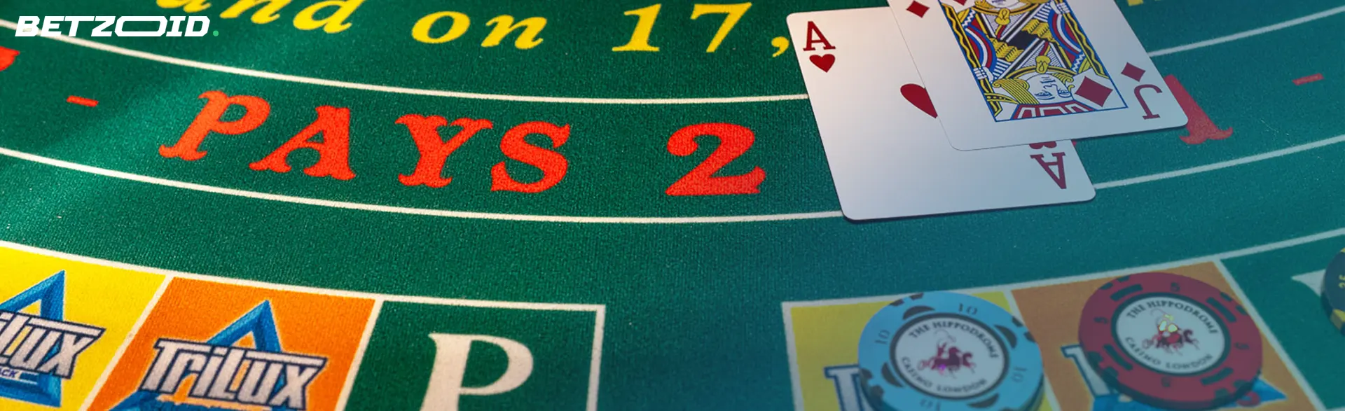 A pair of blackjack cards on a green felt table, symbolizing the excitement and anticipation of playing blackjack at online casinos.