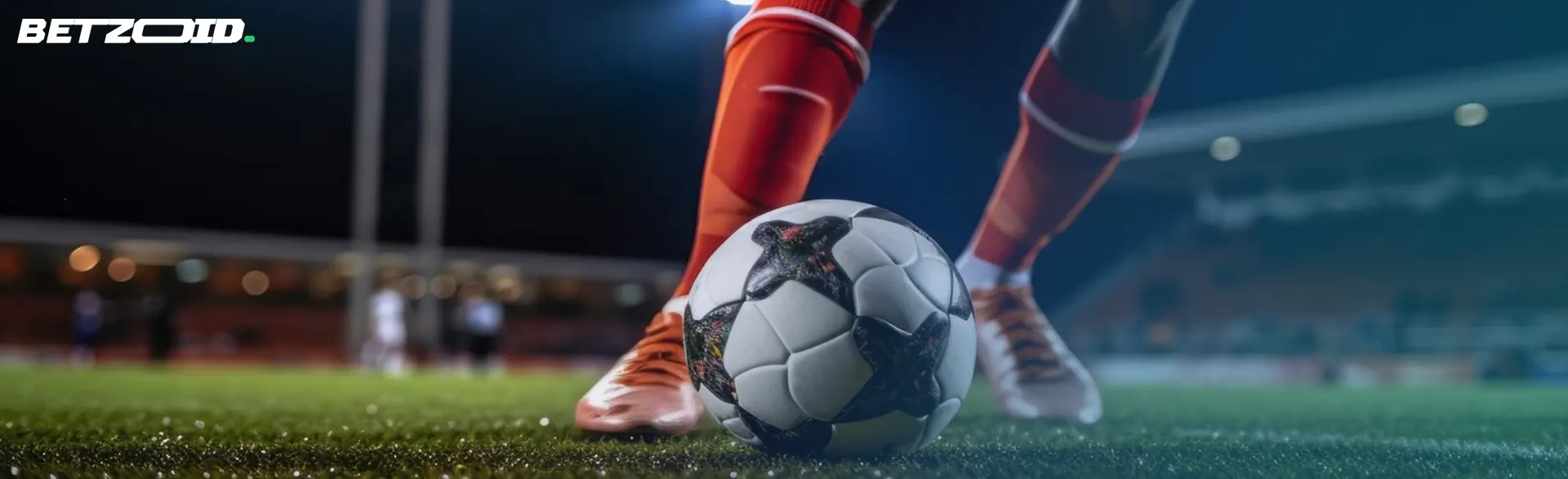 Piernas de futbolista preparándose para golpear un balón, ilustrando la acción en sitios de apuestas de fútbol.