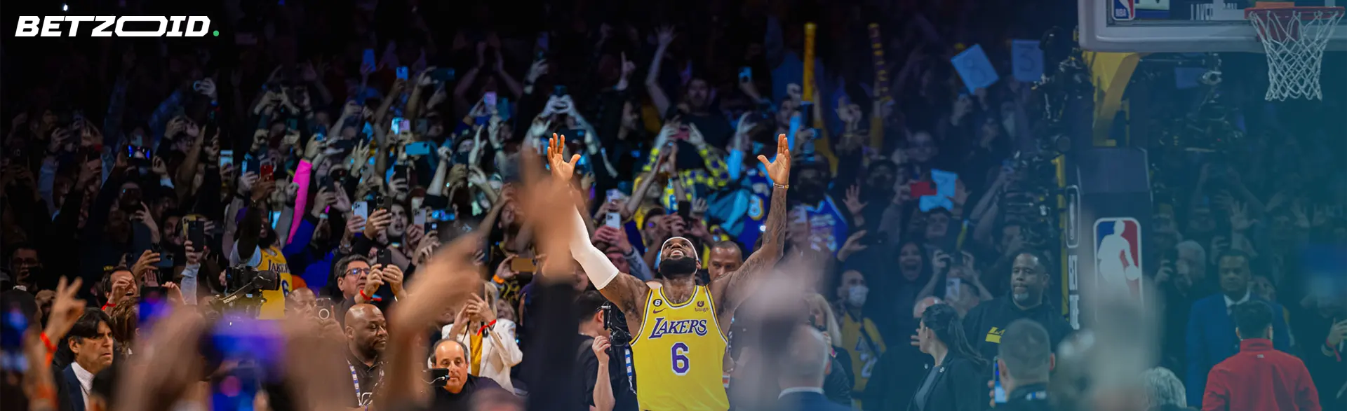 A basketball player celebrates amidst a cheering crowd, capturing the excitement of NBA betting websites.