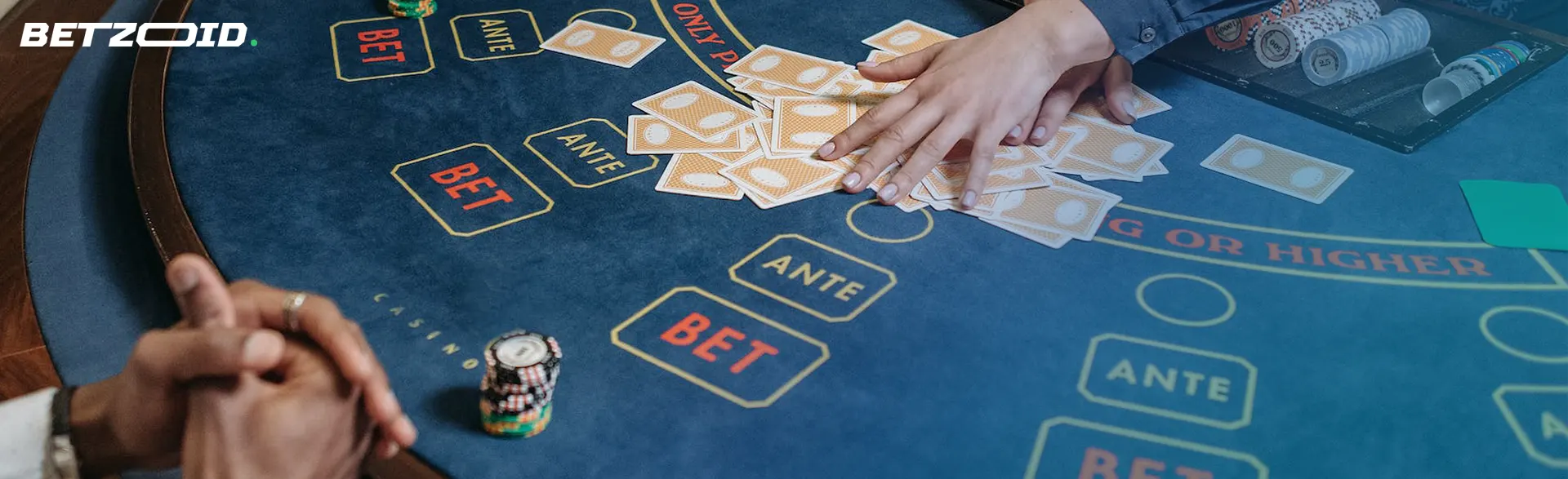 A hand of cards and a colorful assortment of casino chips on a table represent the latest online casinos.