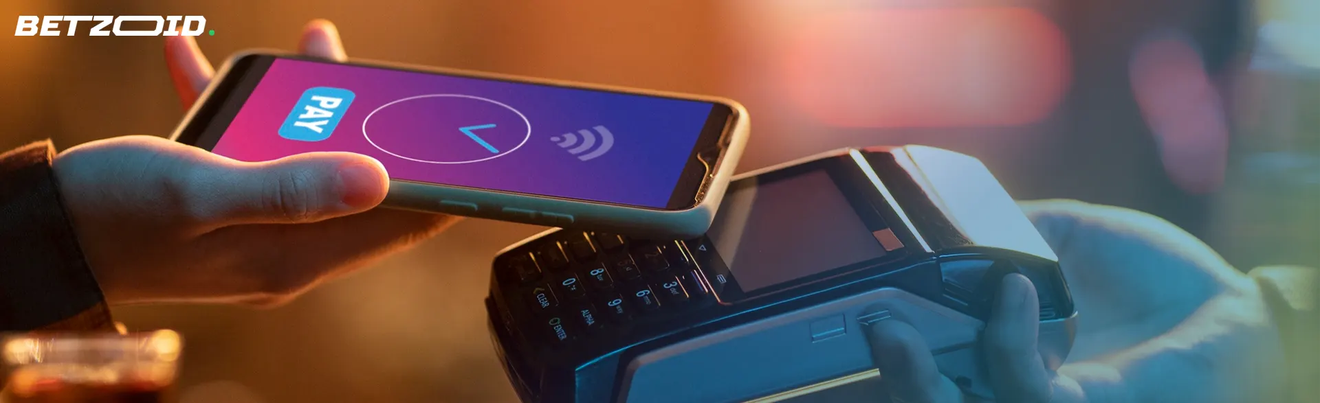 A smartphone completing a transaction over a payment terminal, illustrating pay by phone casinos.