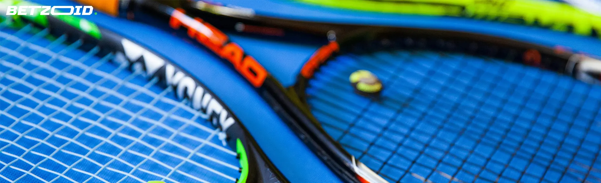 Close-up of tennis rackets and tennis balls on a blue court surface, symbolizing Manitoba best sportsbooks.