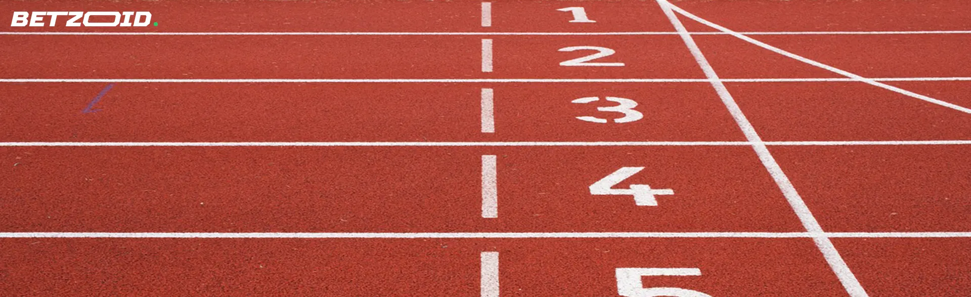 A close-up of a red running track showing numbered lanes.