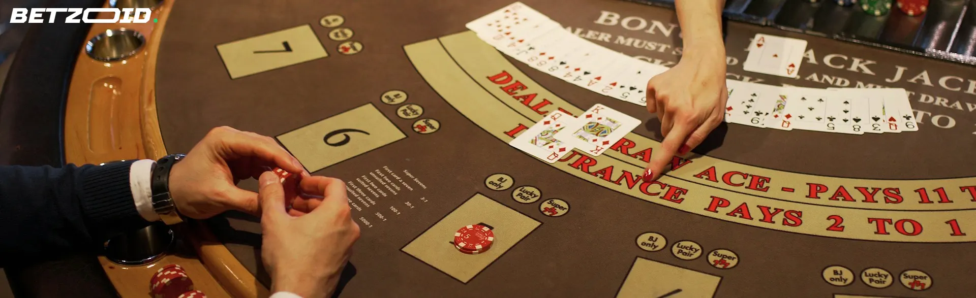 A close-up view of a blackjack table with a dealer's hand distributing cards, highlighting the excitement and strategy involved at the best bonus online casinos in Canada.