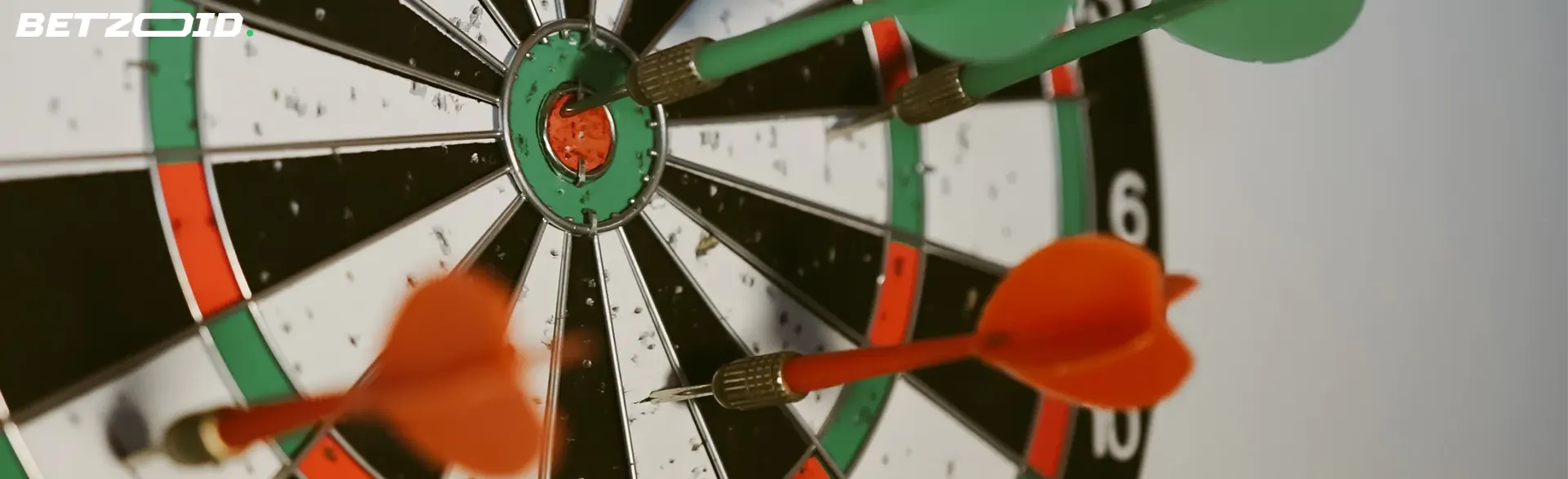 Dartboard with darts hitting the bullseye, representing the best free bet offers available in Canada.