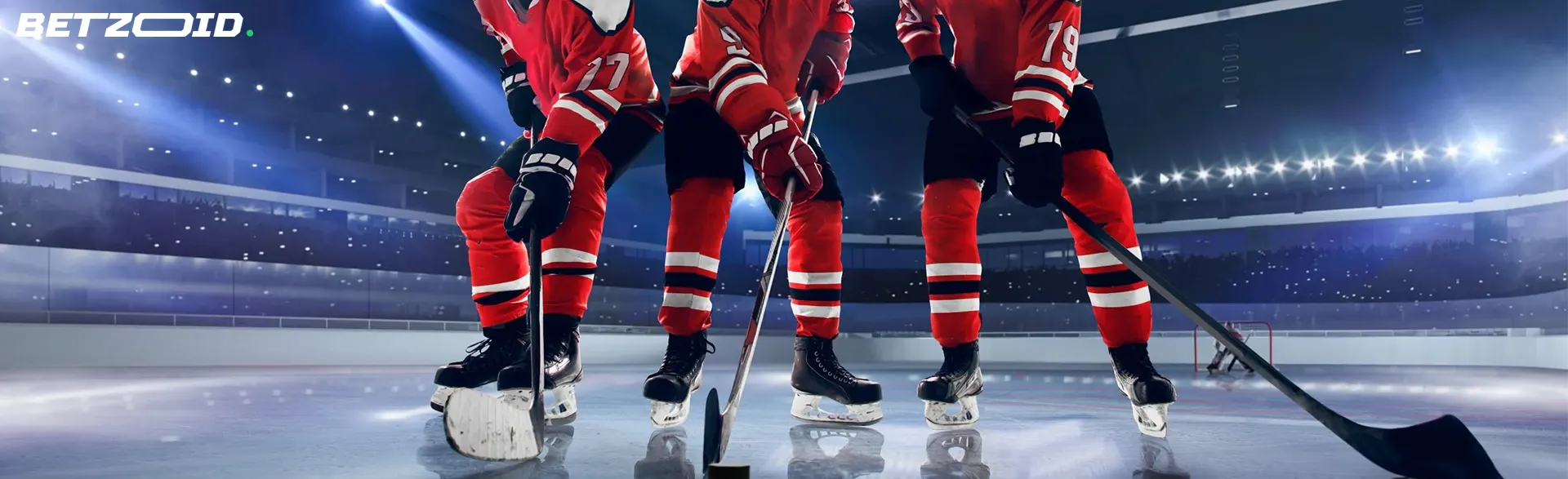Hockey players in red uniforms on an ice rink, representing the best NHL betting site in Canada.