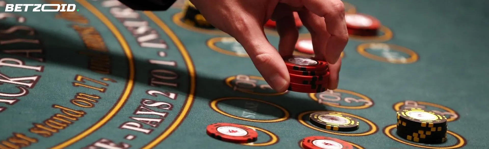 A close-up of a hand placing chips on a green casino table, illustrating the excitement and opportunities at big bonus casino sites in Canada.