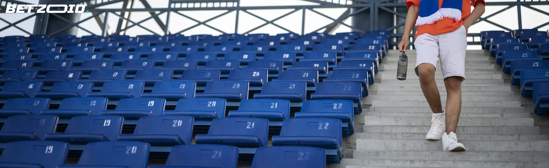 A person walking down the steps of a stadium, symbolizing bookmakers' free bets available in Canada.