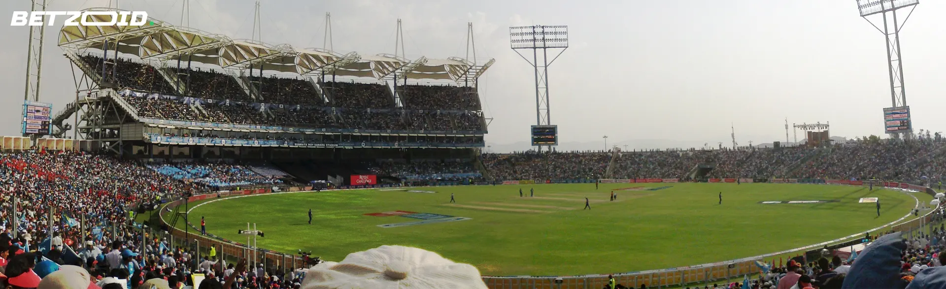 A packed cricket stadium with spectators watching a live match, representing licensed online betting platforms for cricket fans in Canada.