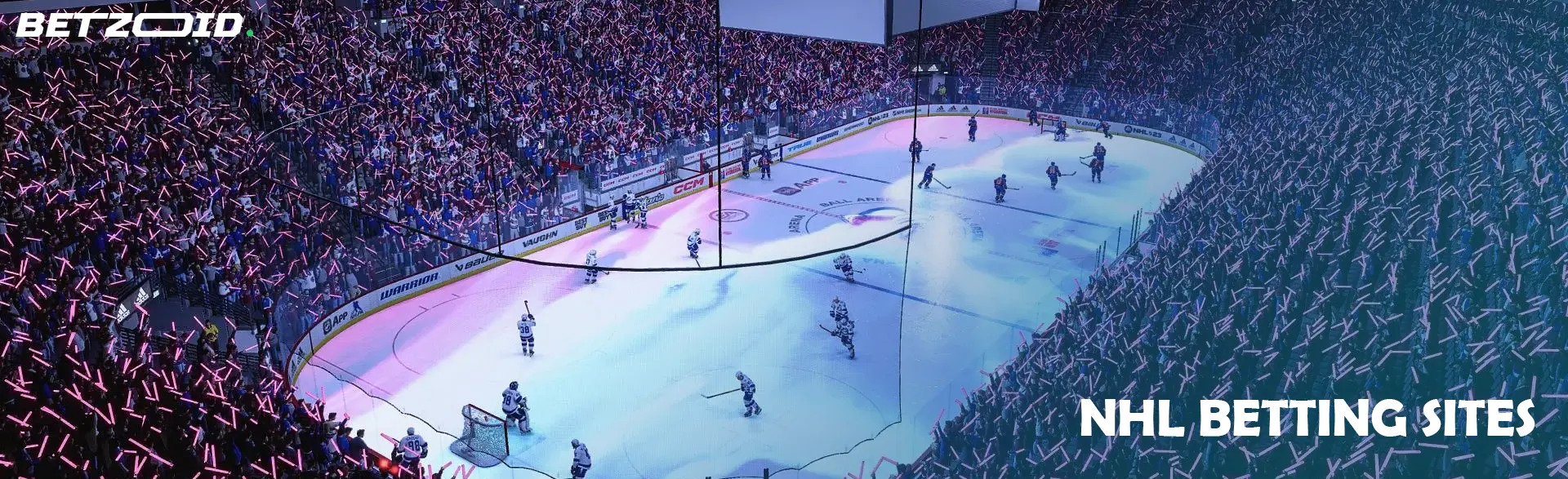 NHL gambling sites in Canada feature vibrant scenes like this crowded stadium with fans holding glowing sticks during a game.