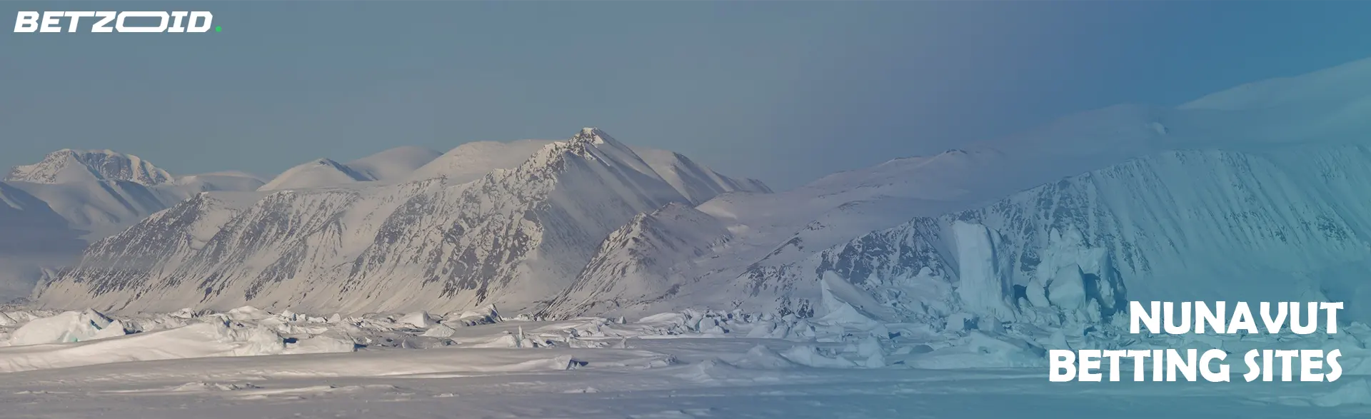 Scenic view of snow-covered mountains and icebergs in Nunavut, highlighting Nunavut betting sites.