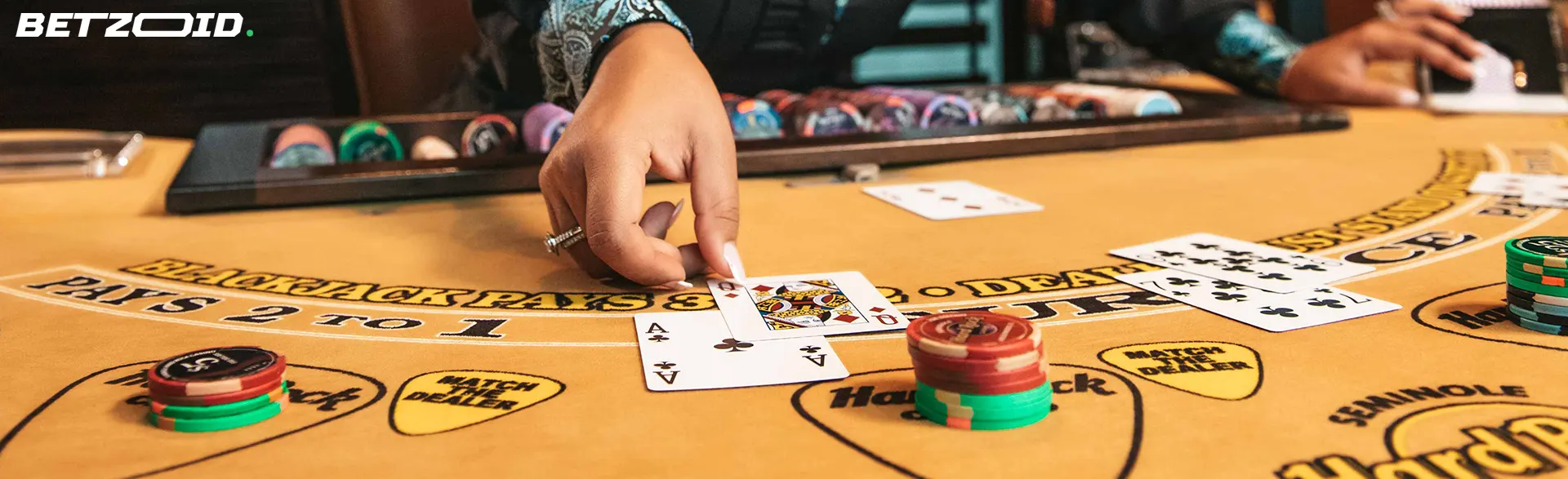 Intense blackjack game in action, capturing a dealer placing cards on the table, representing online casinos with no deposit limits in Canada.