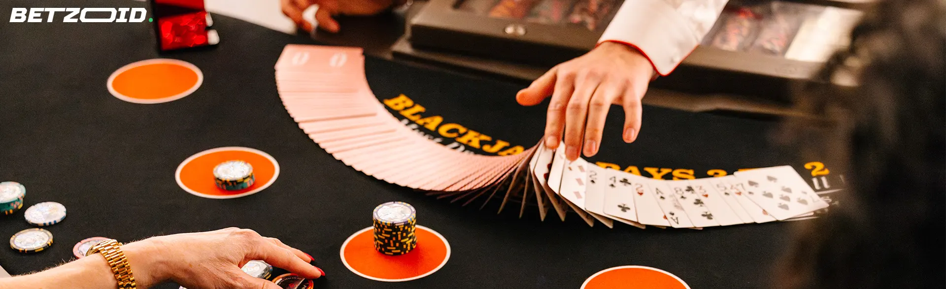 Close-up view of a blackjack table with a dealer fanning out a deck of cards, symbolizing unlimited casinos in Canada.