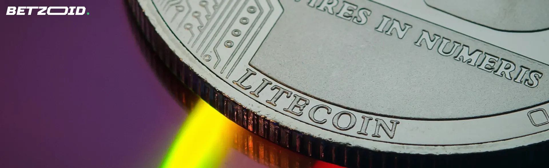 Close-up of a Litecoin coin with engraved details, reflecting colorful light.