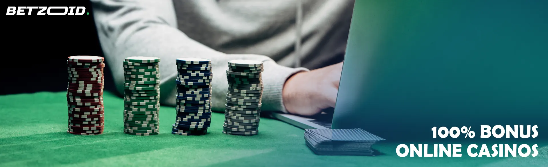 Poker chips and a man at a laptop on a green table.