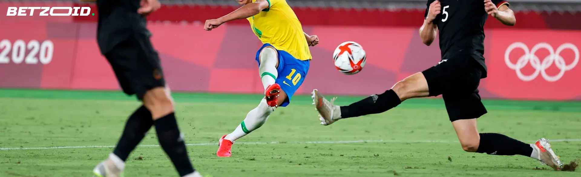 A football player kicks the ball during a football match.