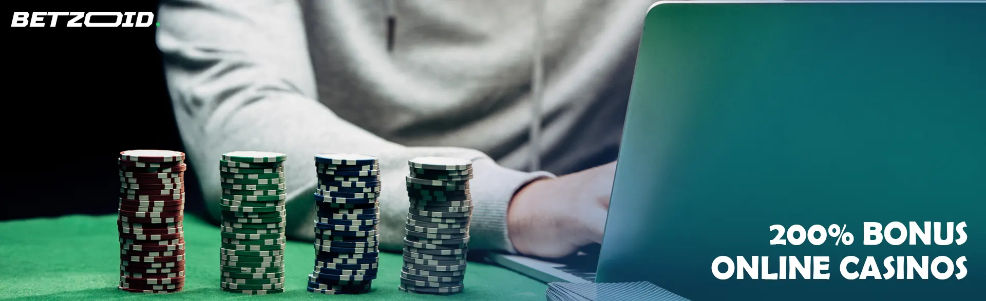 The player behind the laptop next to stacks of chips.