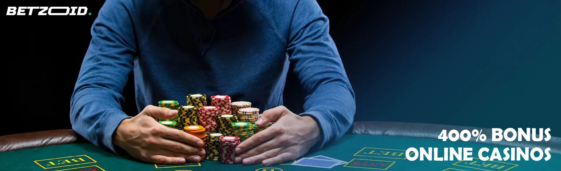 A player is holding a pile of chips on a casino table.