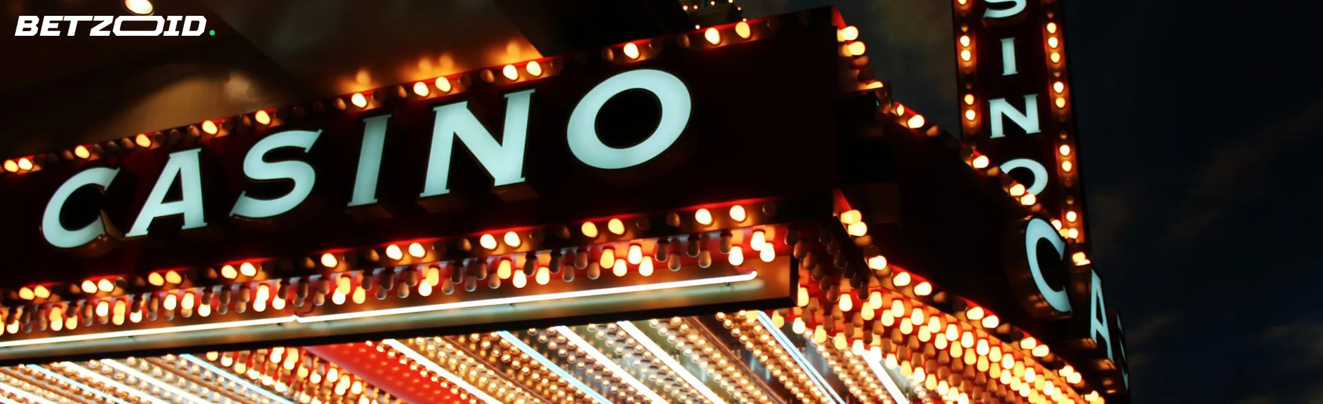 Casino neon sign at night with bright lights.