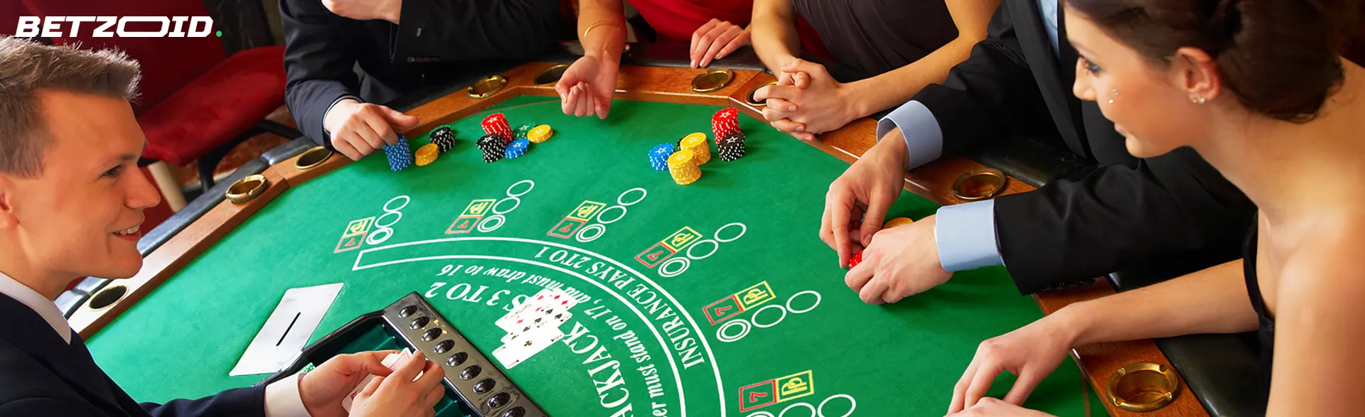 Players sit around a roulette table.