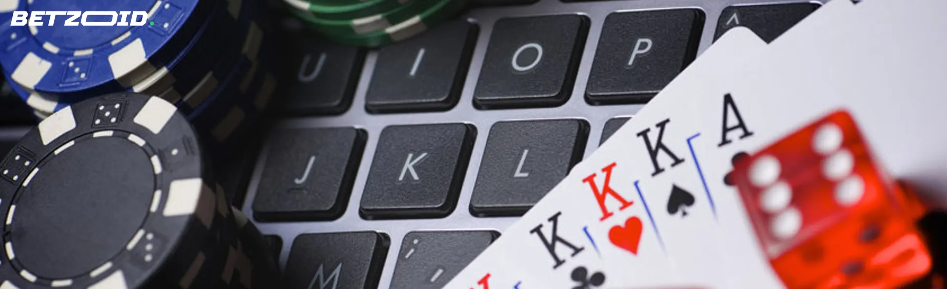 Poker cards and chips on a laptop keyboard.