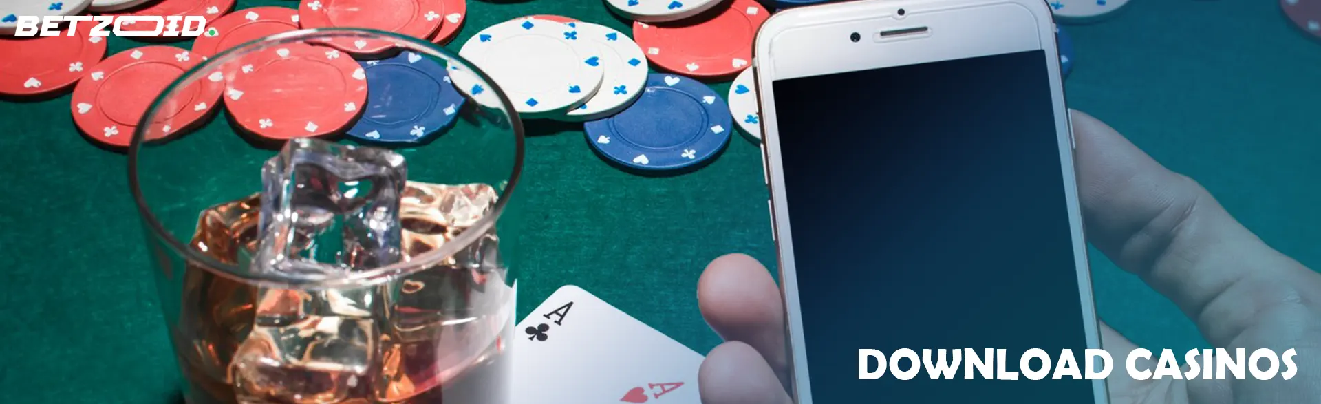 The player holds the phone next to a glass of drink, cards and chips.