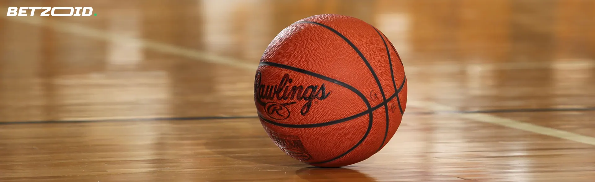 A basketball on a wooden court.