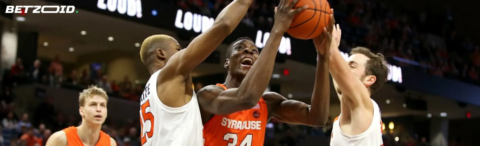 Basketball players fight for the ball on the court.