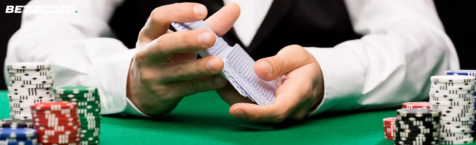 The player shuffles the cards next to the casino chips.