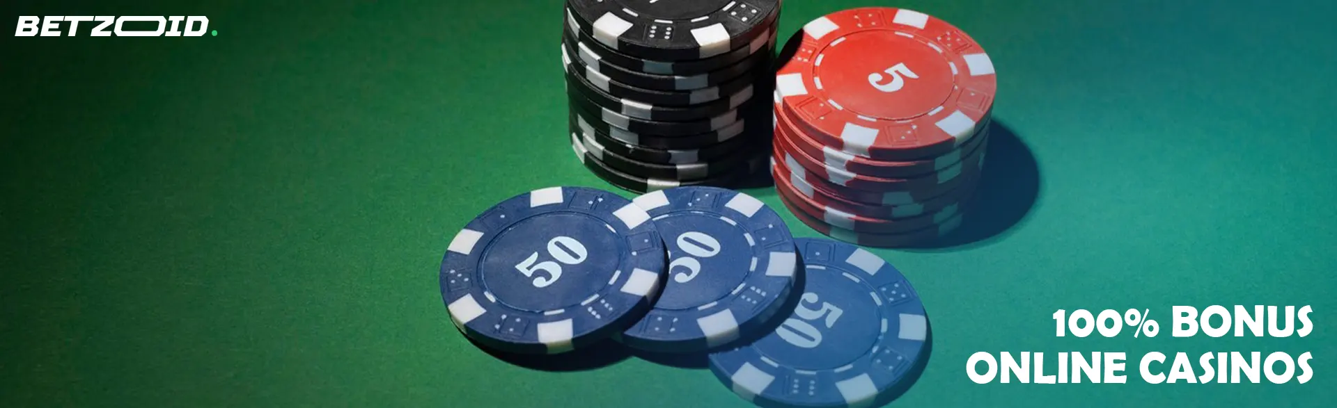 Chips of different denominations on a green table.