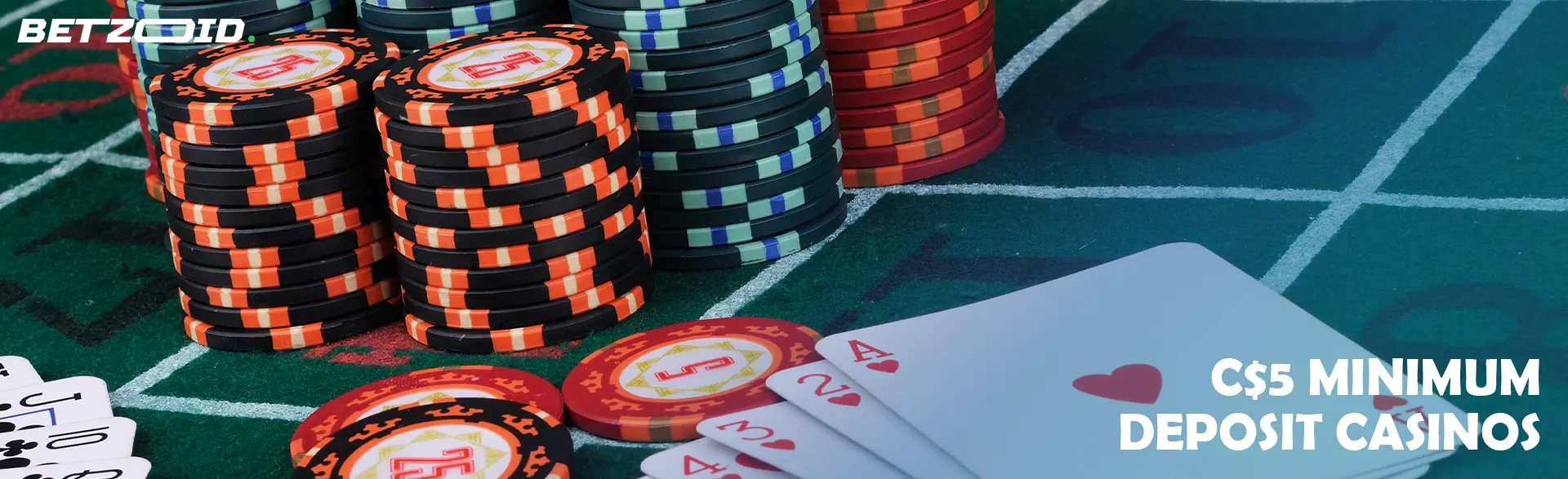 Stacks of chips next to cards on the casino table.
