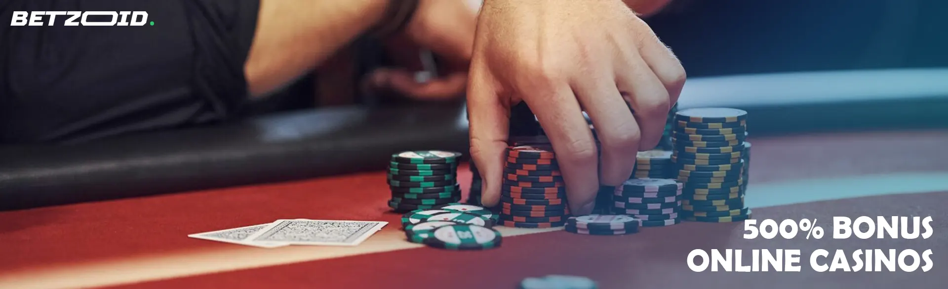 A player holds chips on the casino table.