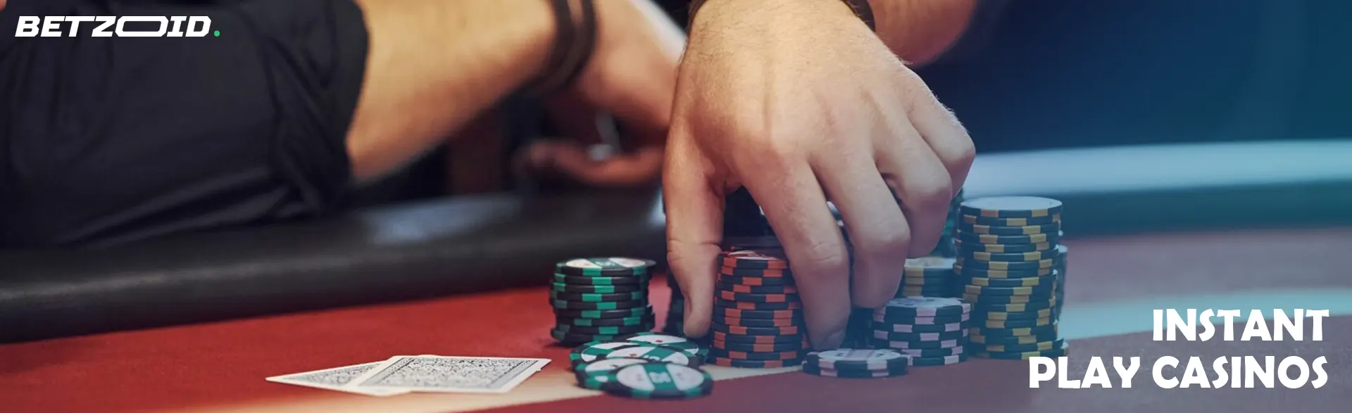 A player holds chips on the casino table.