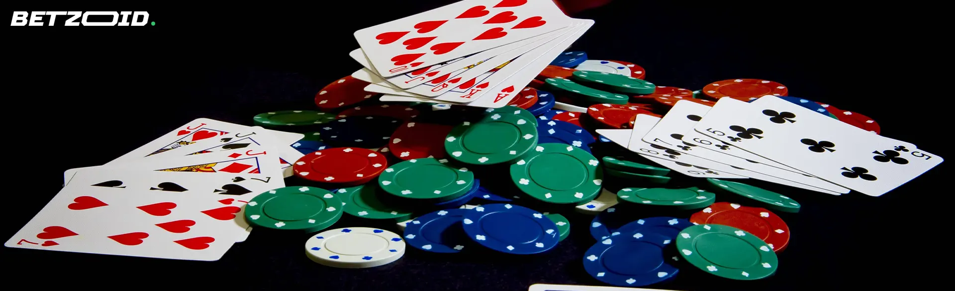 A pile of casino chips and cards on the table.