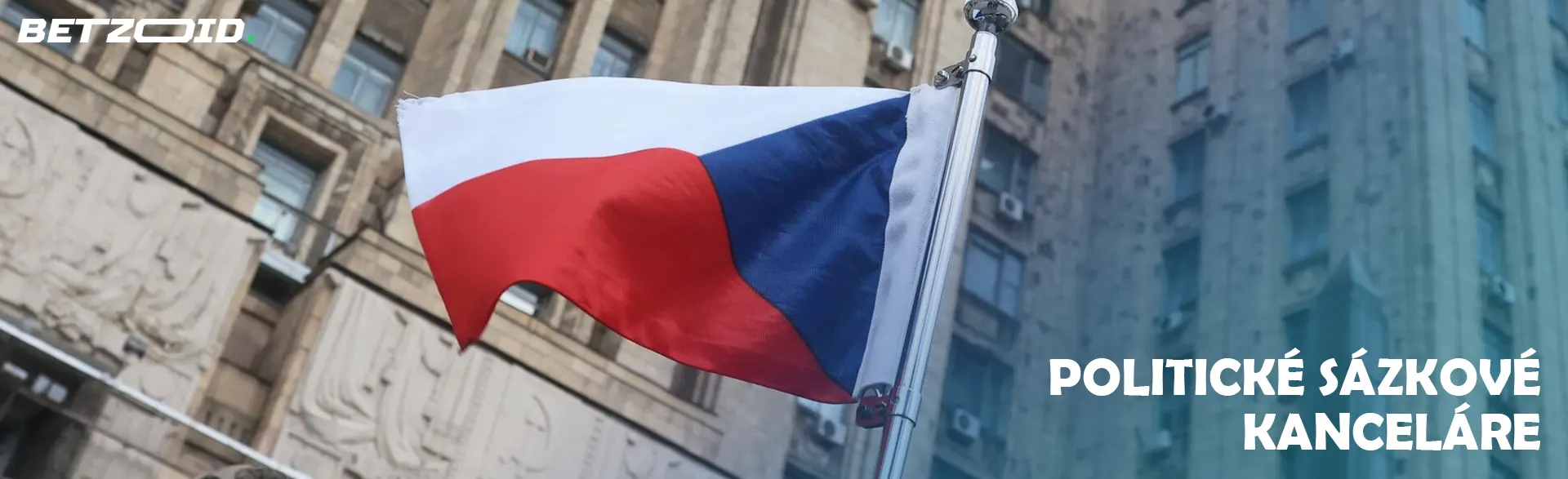 Vlajka České republiky na pozadí budovy.