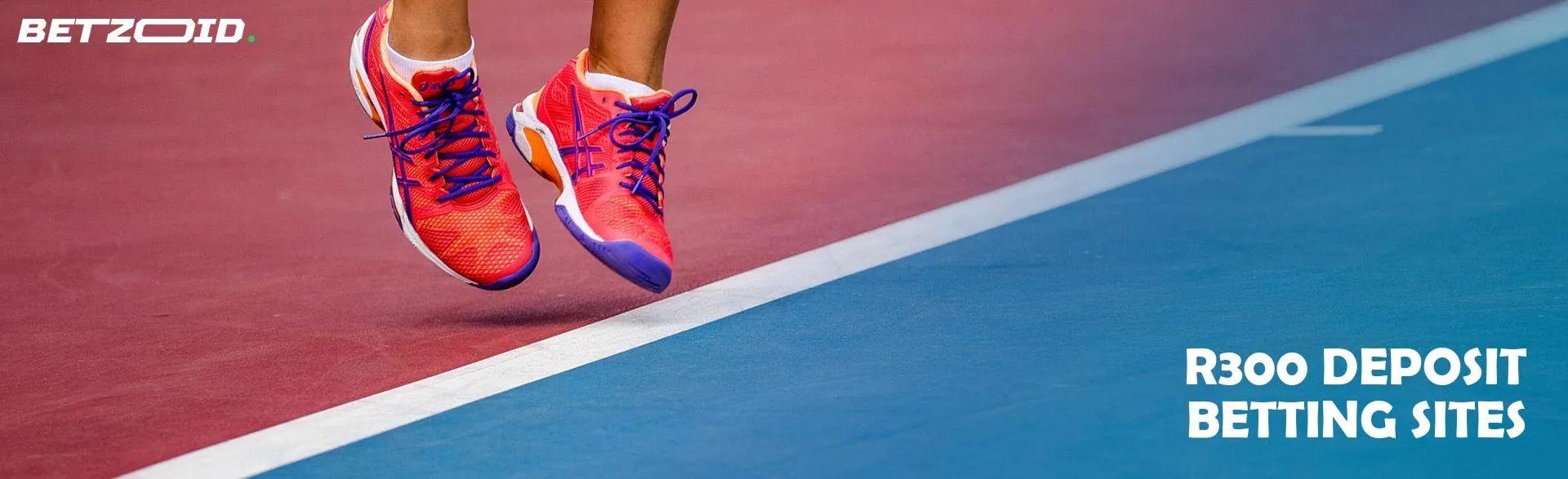 An athlete in bright sneakers jumps on the sports ground.