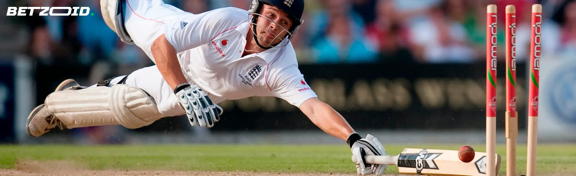 A cricketer tries to hit the ball.