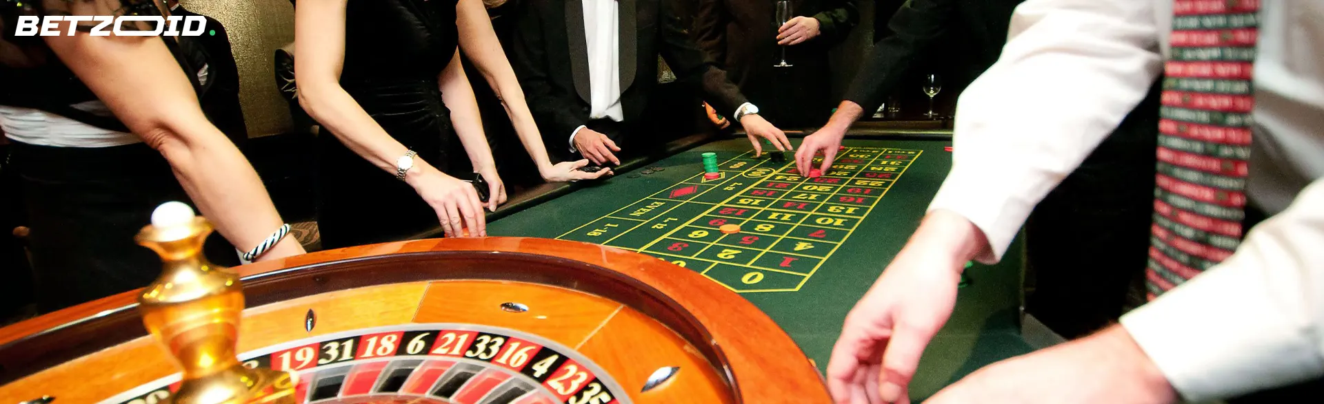 Players around casino roulette.