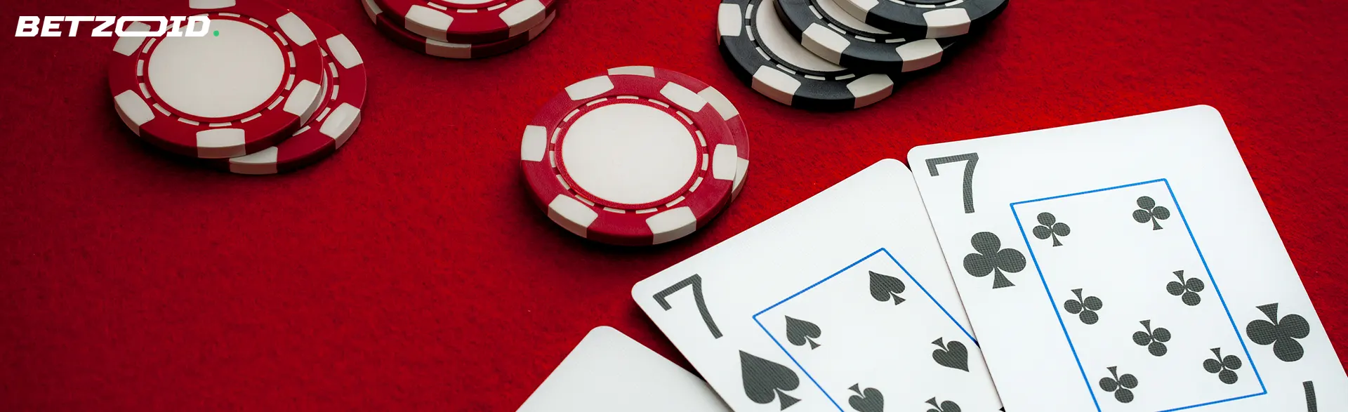 Casino cards and chips on a red table.