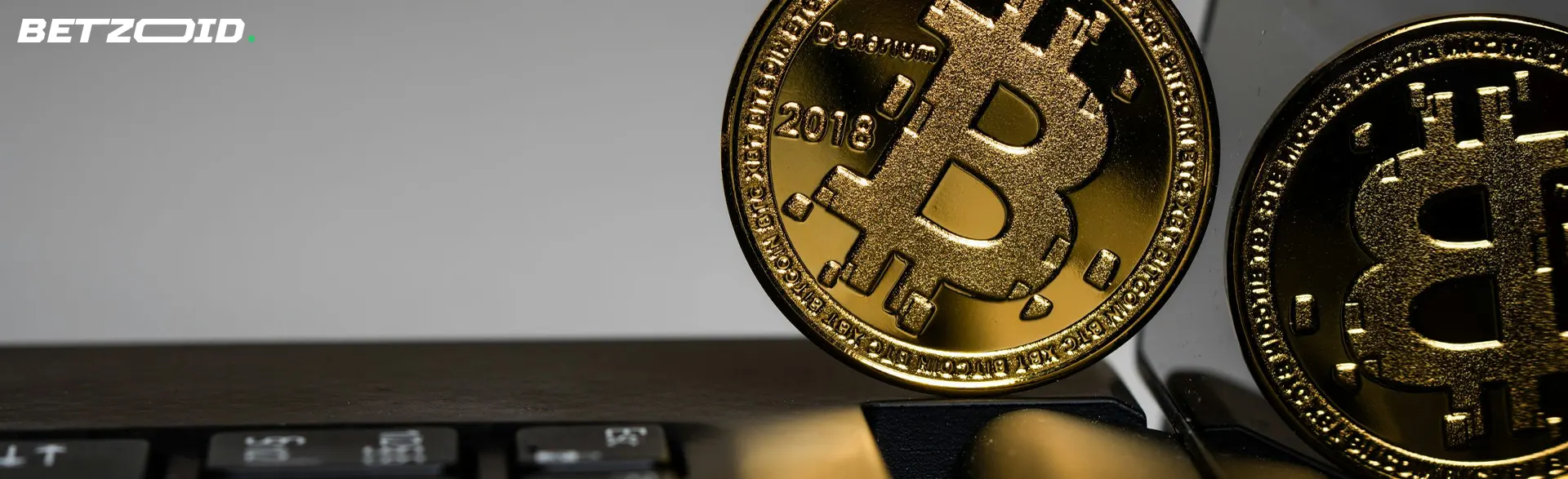 Bitcoin coin on laptop keyboard.