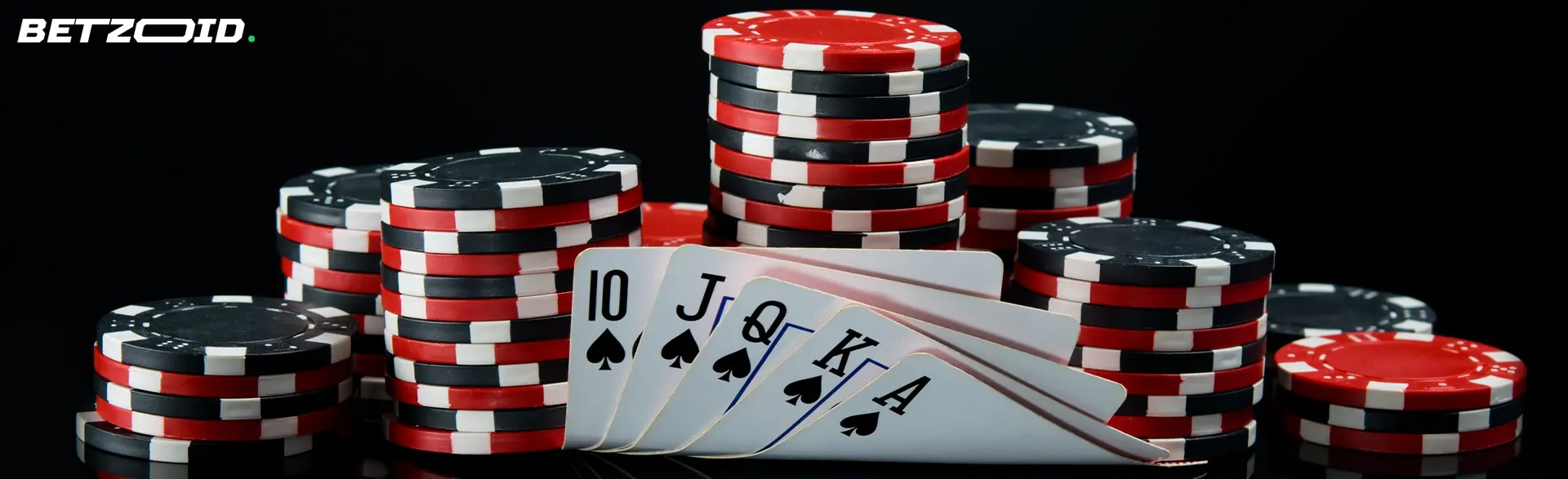 Chips and cards on a dark background.