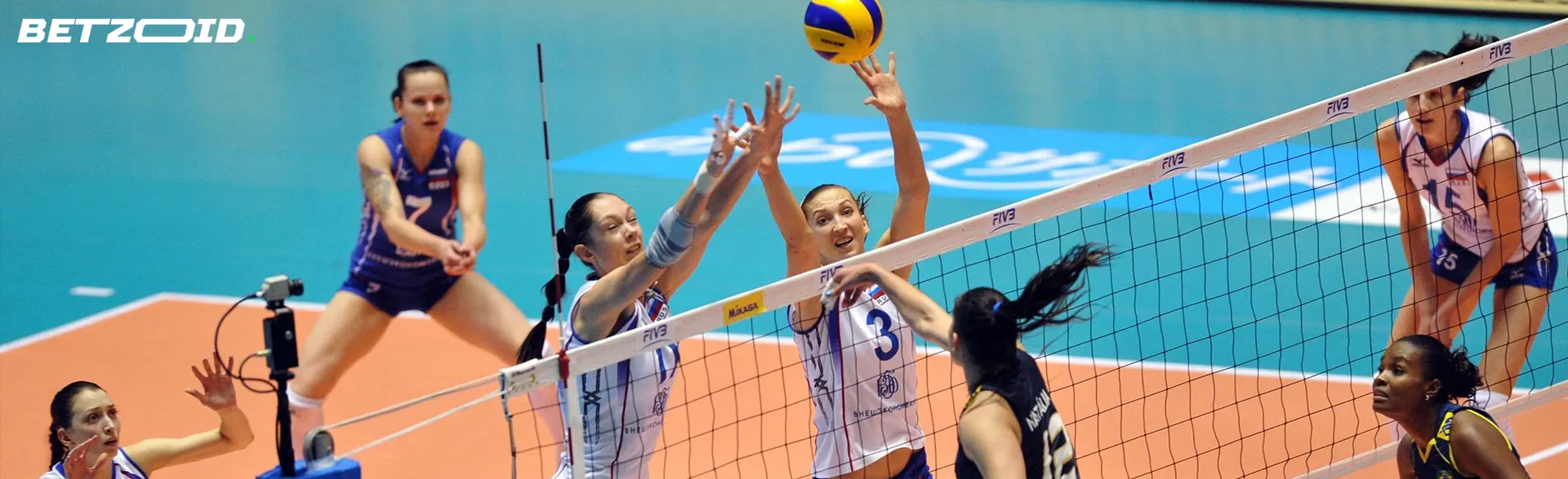 Volleyball players in action during a match.