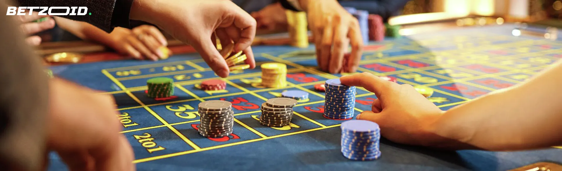 Players place bets with chips on the casino table.