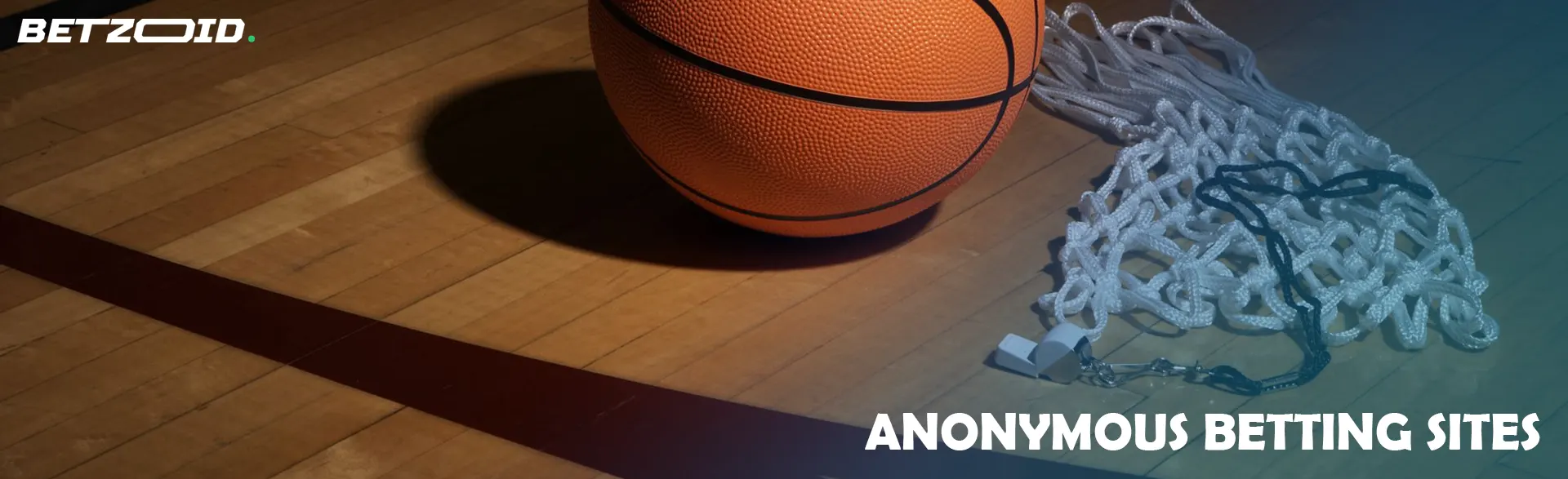 The basketball lies on the floor along with the net.