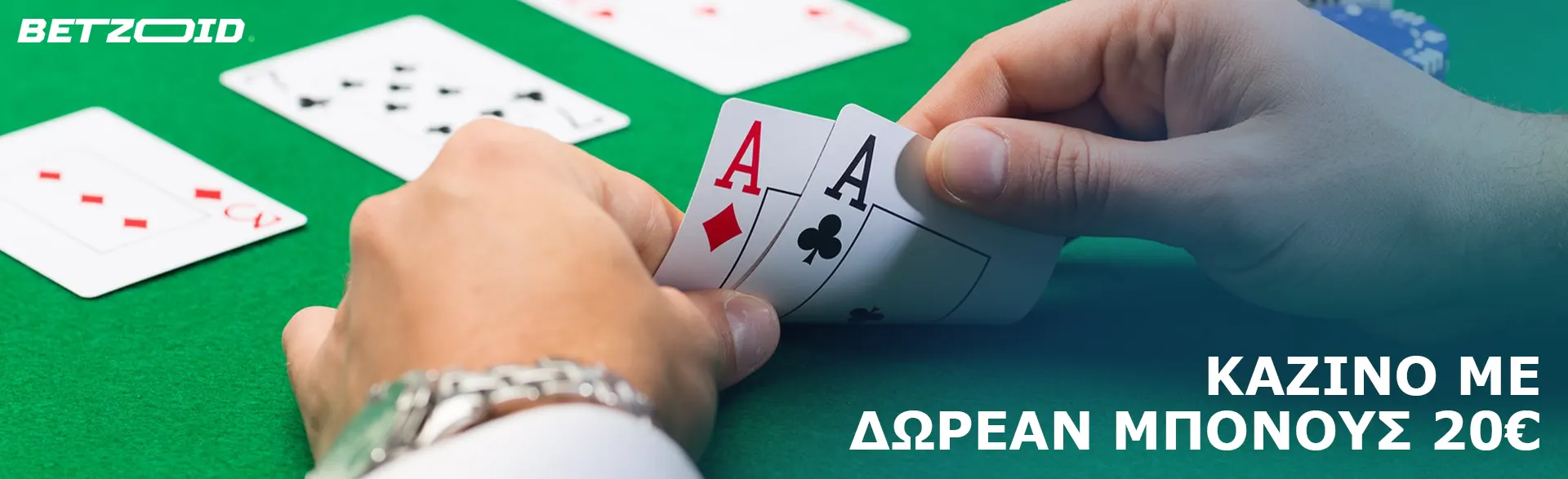 Ένας παίκτης κρατά κάρτες στο τραπέζι του καζίνο.