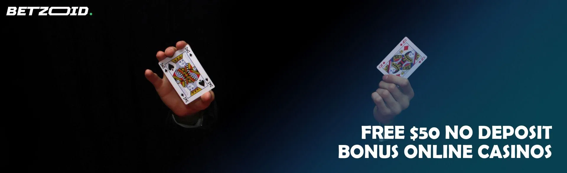 A man is holding two cards on a dark background.