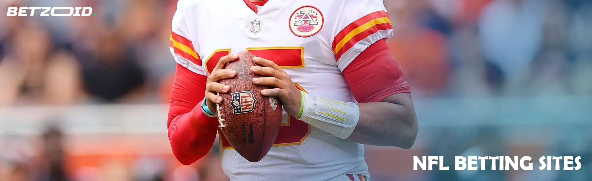 American football player holding the ball during the game.