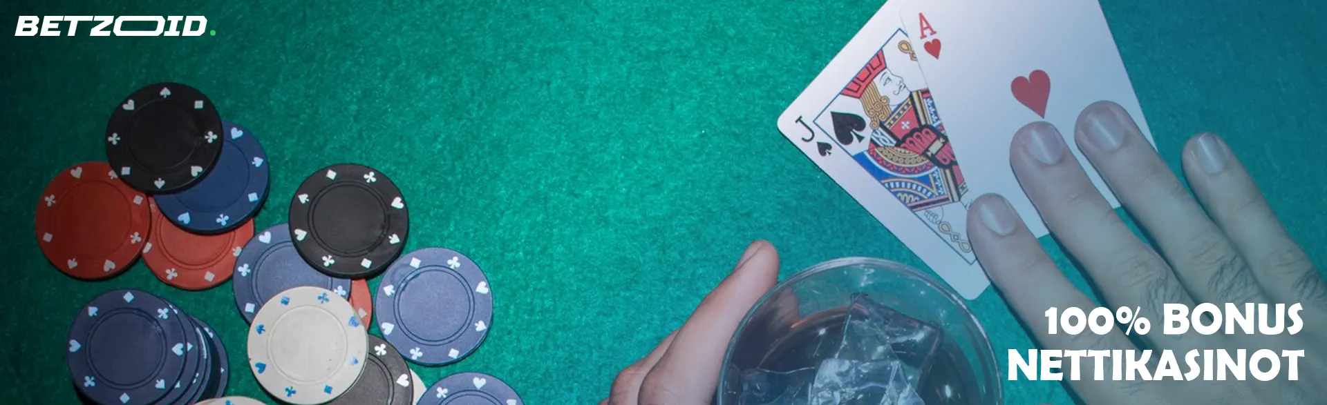 Pelaajalla on kaksi korttia kasinon pelimerkkien ja juoman vieressä lasissa.