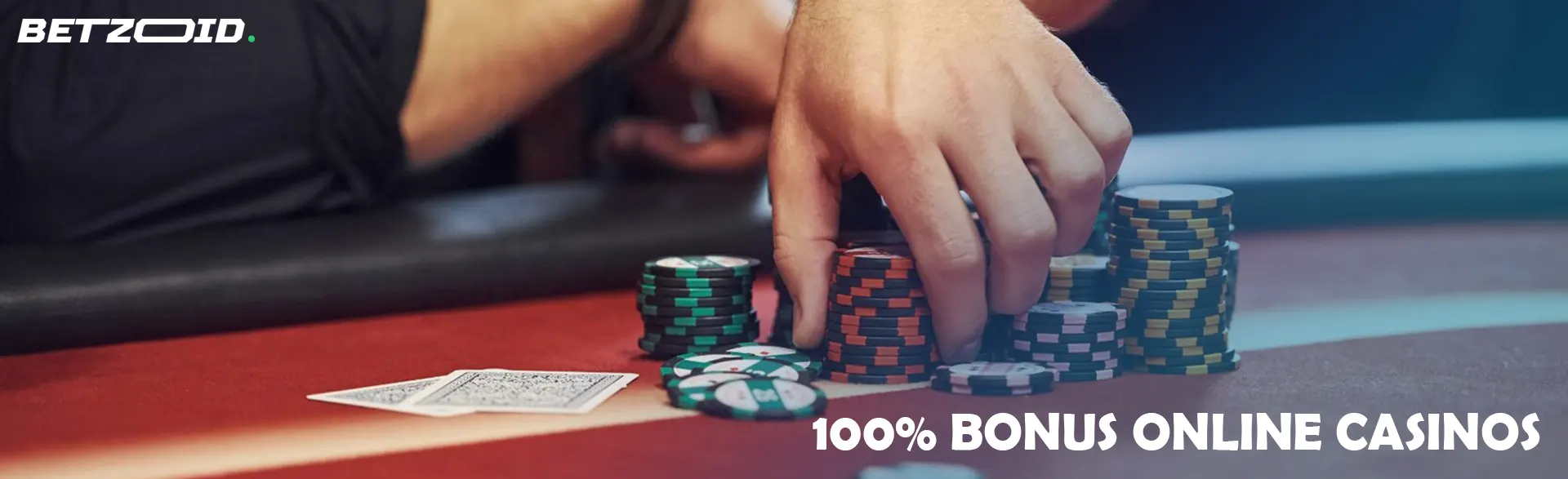 A player holds chips on a casino table.