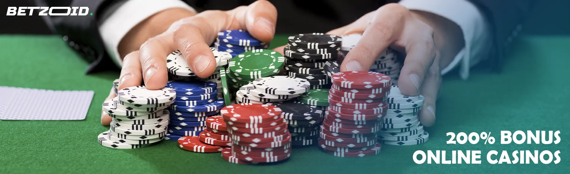 A player holds a pile of chips on a casino table.